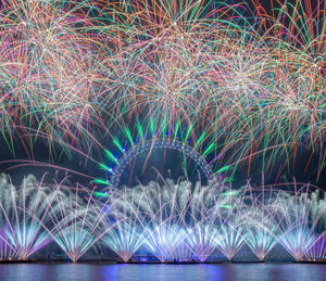 Low angle view of firework display at night