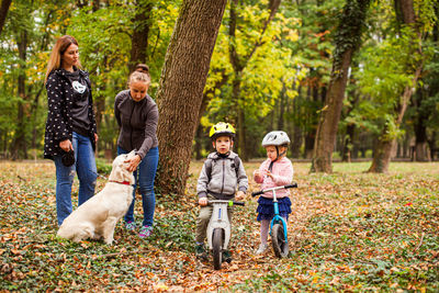 Rear view of people in forest during autumn