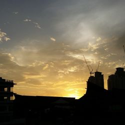 Silhouette of built structure against sunset sky