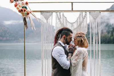 Young couple standing in water