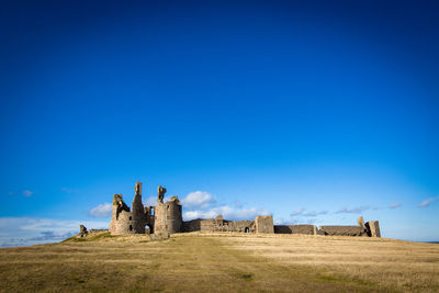 Panoramic view of landscape against clear blue sky