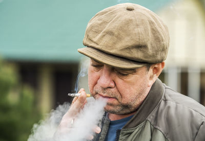 Portrait of man smoking cigarette