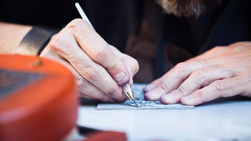 Midsection of man working on table