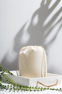 Close-up of bread on table against white wall