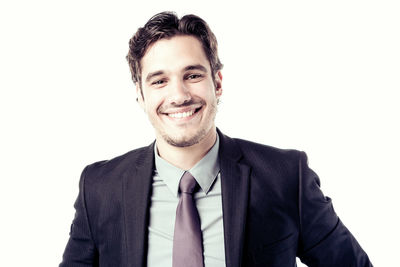 Portrait of a smiling young man against white background