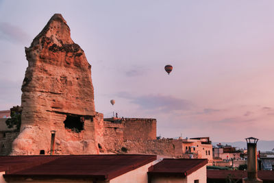 Traditional view of some hot air balloons flying at down in cappadocia to admire rock formations