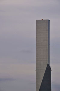 Low angle view of building against cloudy sky