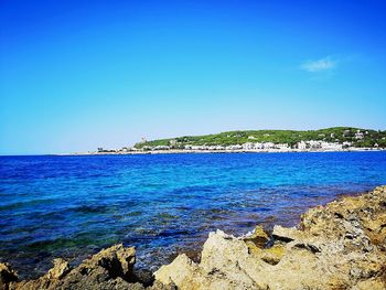 Scenic view of sea against clear blue sky