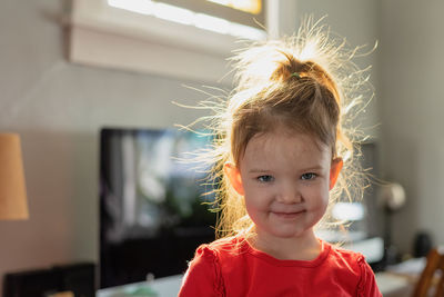 Portrait of cute girl with messy hair at home