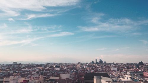 Cityscape against cloudy sky