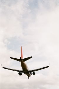 Low angle view of airplane against sky