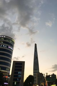 Low angle view of modern building against cloudy sky