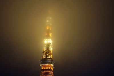 Illuminated city against sky at night