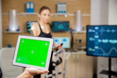 Portrait of woman using digital tablet in office