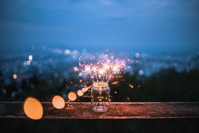 Close-up of sparklers in jar at night