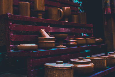 Close-up of old utensils on shelves at market stall