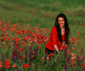 Portrait of a smiling young woman on field