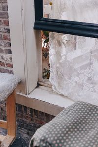 Close-up of window on wooden door of building