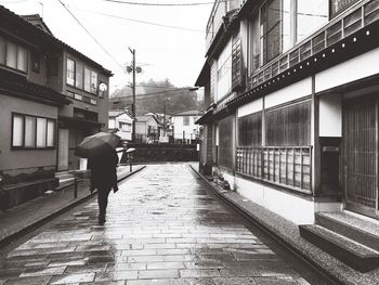 Man walking on railroad track in city