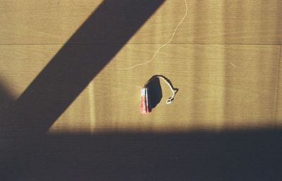 Directly above view of blood stained tampon on wooden table