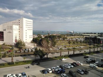 High angle view of traffic on road by buildings against sky