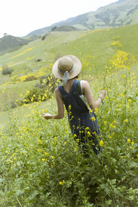 Rear view of woman on field