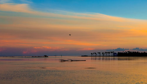 Scenic view of beach against cloudy sky