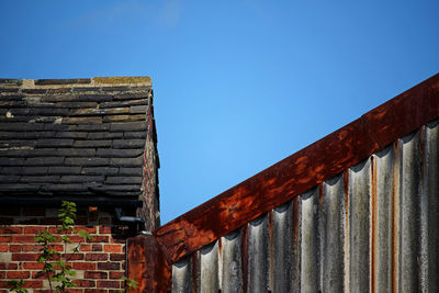 Low angle view of old building against blue sky