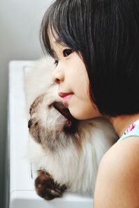 Close-up of cute girl with cat