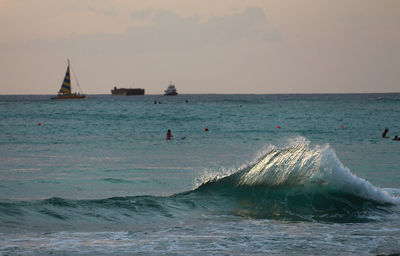 Sailboats in sea against sky