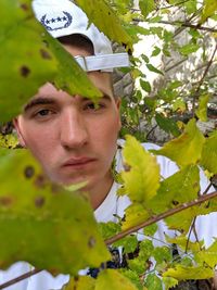 Portrait of man with green leaves