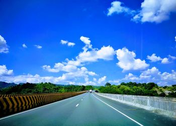 Empty road along countryside landscape