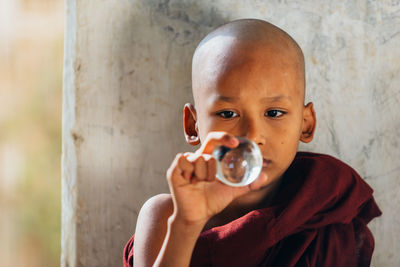 Portrait of cute boy holding bubbles