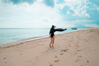 Full length of man on beach against sky