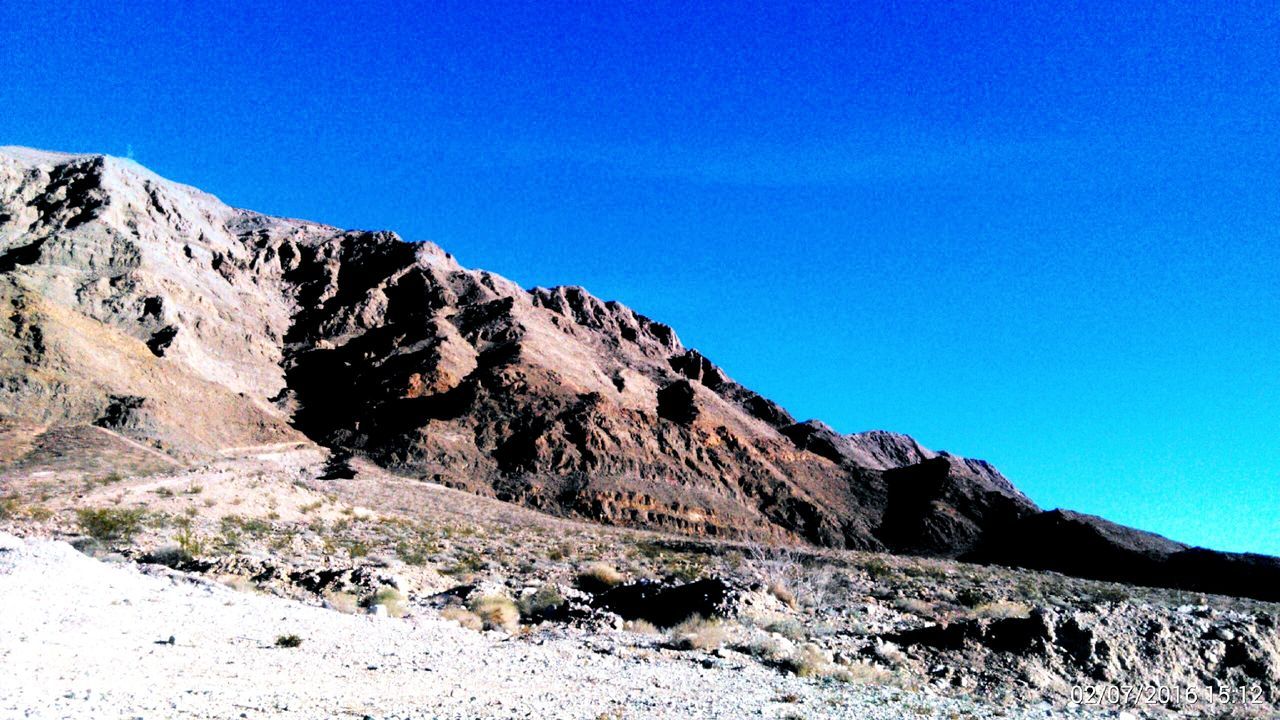 clear sky, mountain, blue, copy space, tranquil scene, tranquility, mountain range, landscape, scenics, beauty in nature, nature, non-urban scene, snow, rock - object, remote, sunlight, rocky mountains, day, rock formation, geology