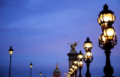 Low angle view of illuminated street light against sky at night