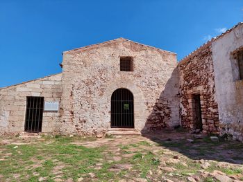 Old building against clear blue sky