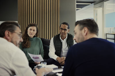 Group of business people having meeting in lobby