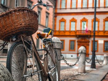 Bicycle parked against building in city