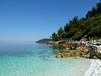 Scenic view of sea against clear blue sky