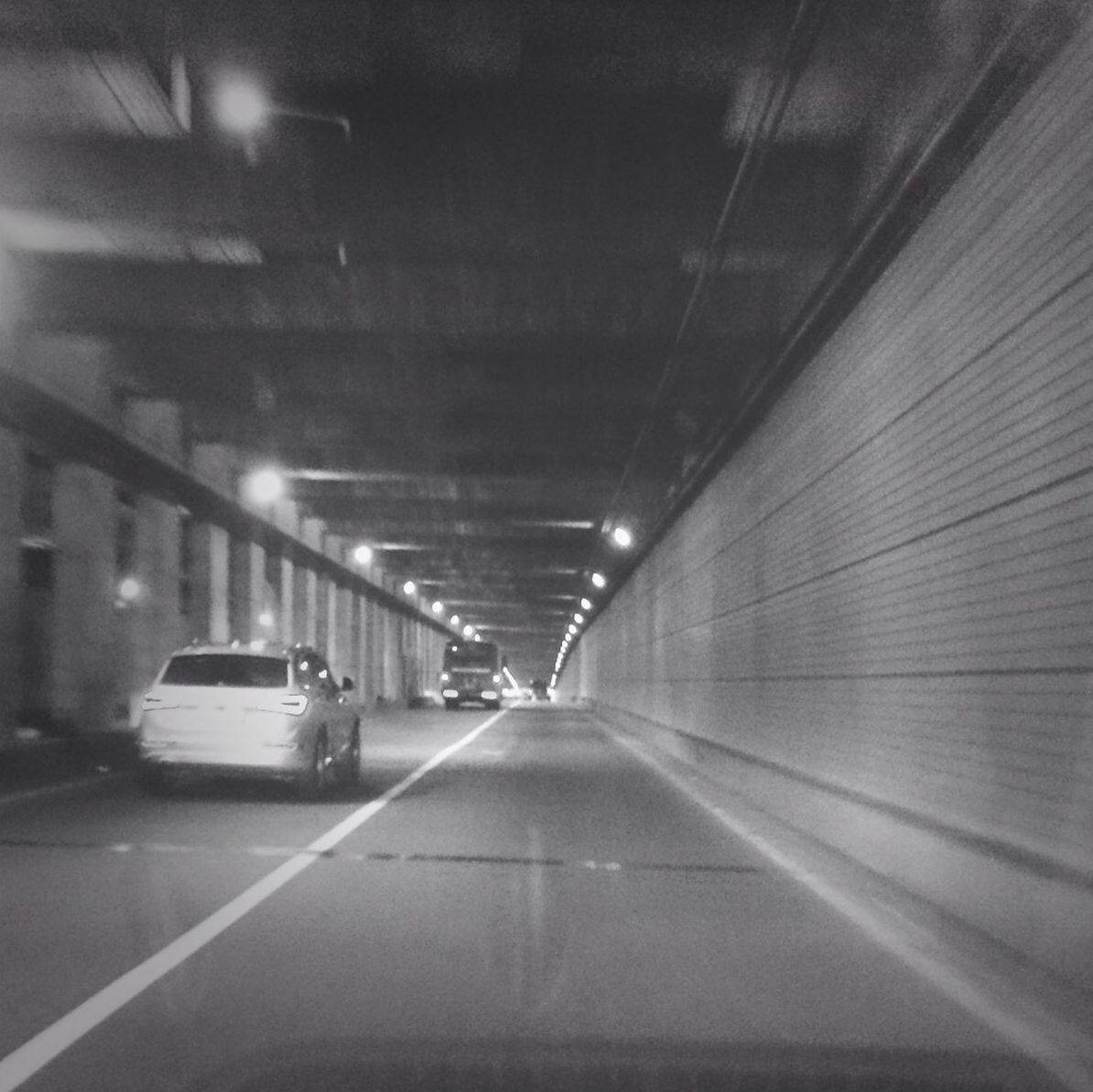 the way forward, transportation, illuminated, diminishing perspective, vanishing point, indoors, road, tunnel, lighting equipment, road marking, architecture, built structure, empty, night, mode of transport, long, street, ceiling, land vehicle, no people