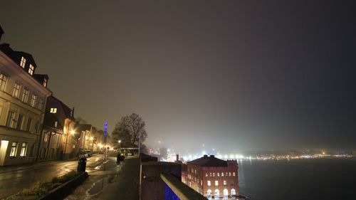 Illuminated city against sky at night