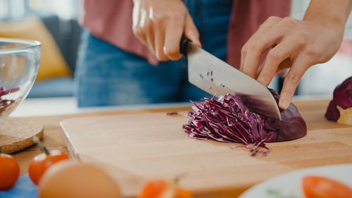 Midsection of man preparing food on table