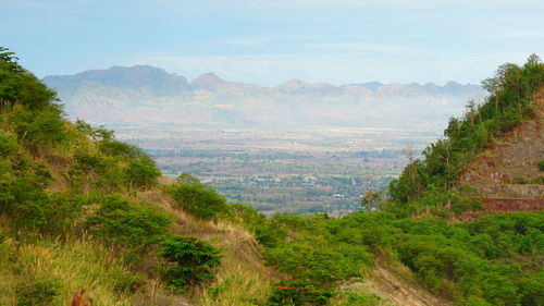 Scenic view of landscape and mountains against sky