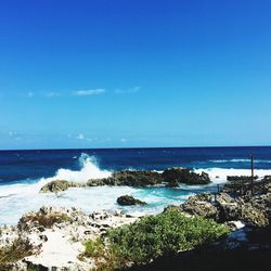 Scenic view of sea against blue sky