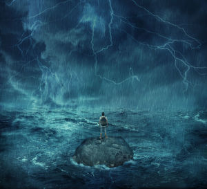 Digital composite image of man standing on rock amidst sea during storm