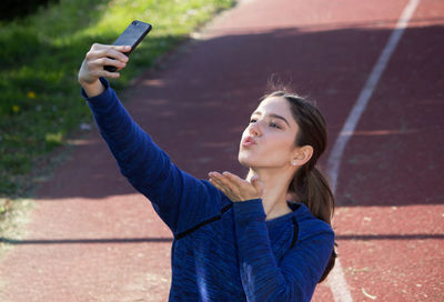 Portrait of man photographing with mobile phone