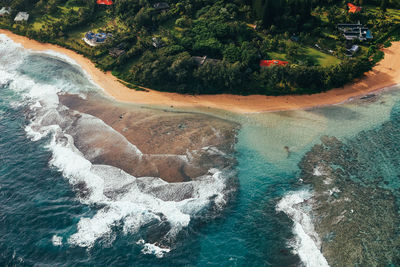 Aerial view from helicopter looking over ocean and coast off kauai, hawaii.