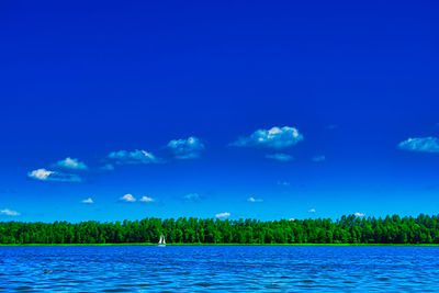 Scenic view of lake against blue sky