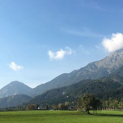 Scenic view of field and mountains against sky